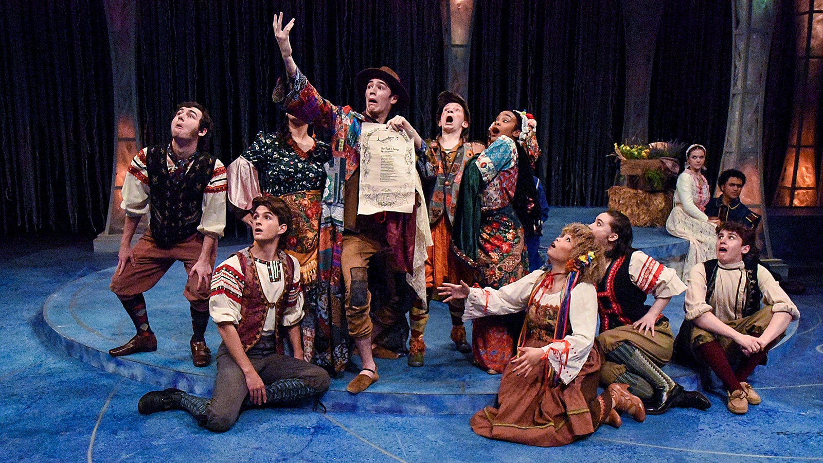 Students perform a musical on stage.