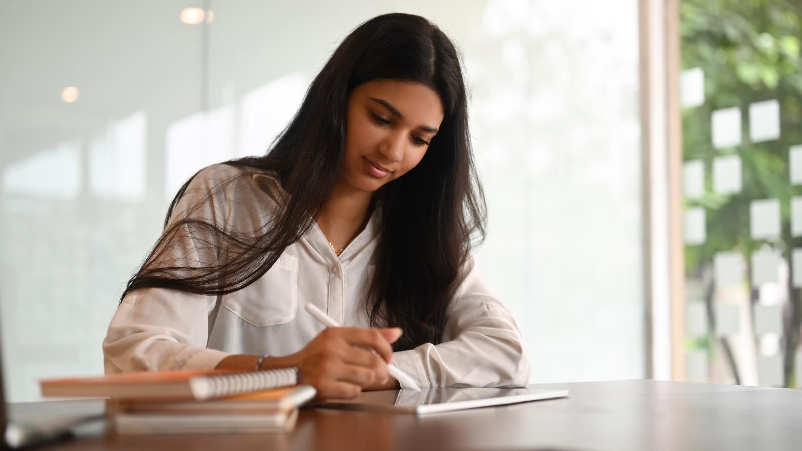 A girl writing at a table