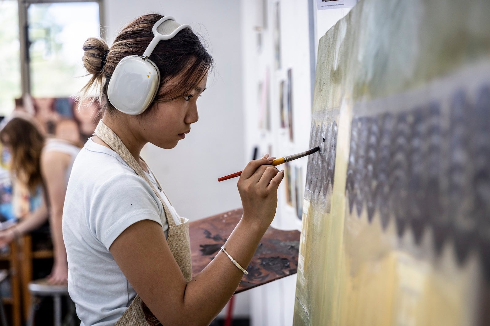 Young woman painting on canvas