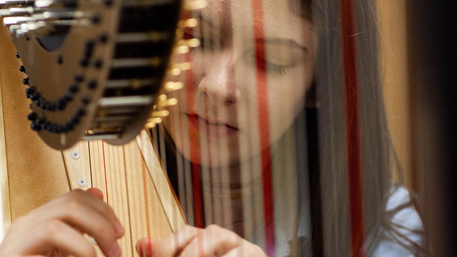 A girl plays the harp