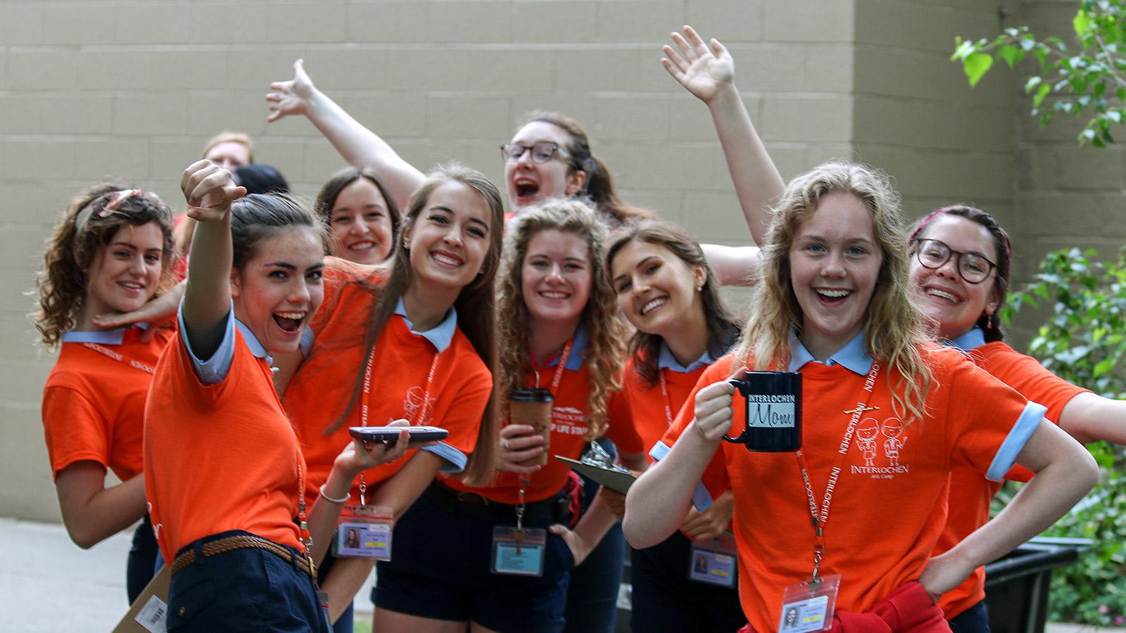 A group of young women in orange t-shirts