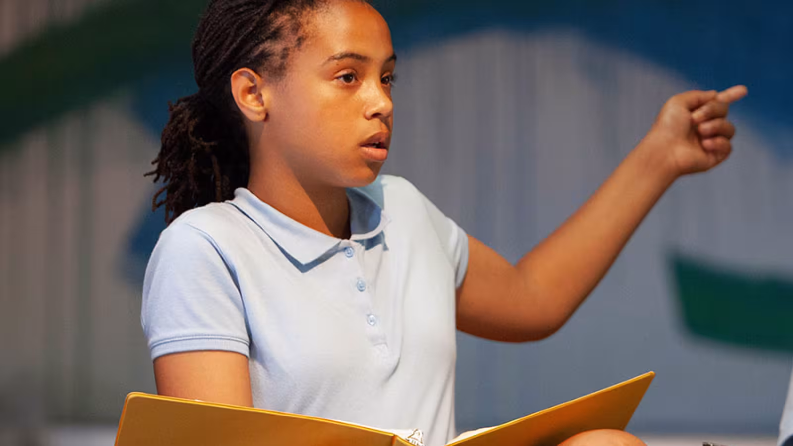 A girl reads from a script
