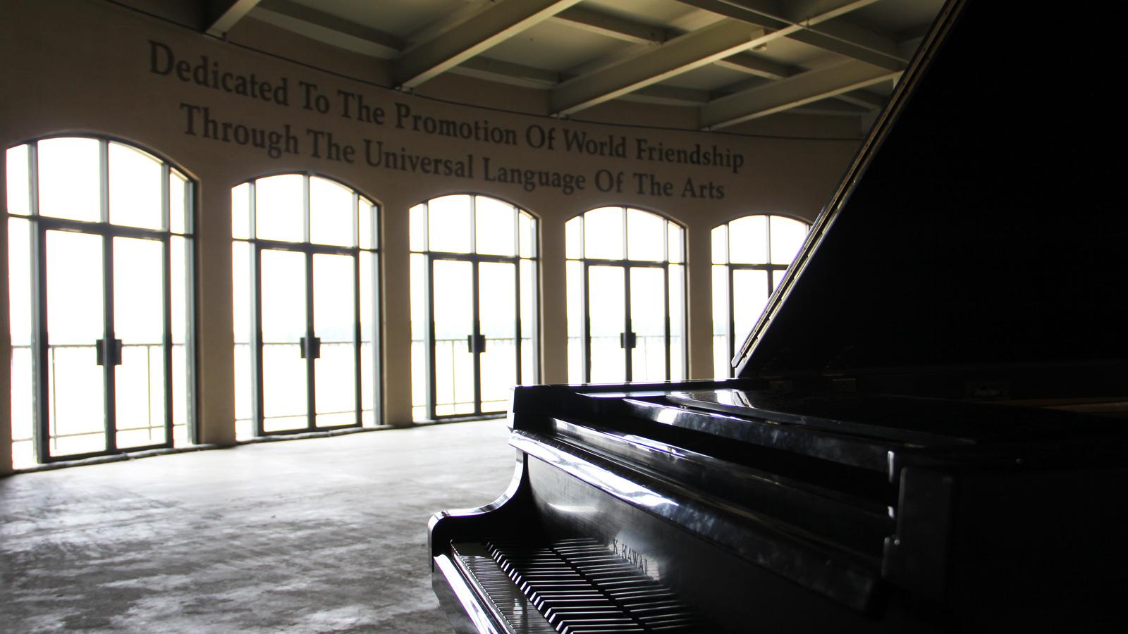 The Kresge Auditorium stage, bearing the inscription "Dedicated to the promotion of world friendship through the universal language of the arts."