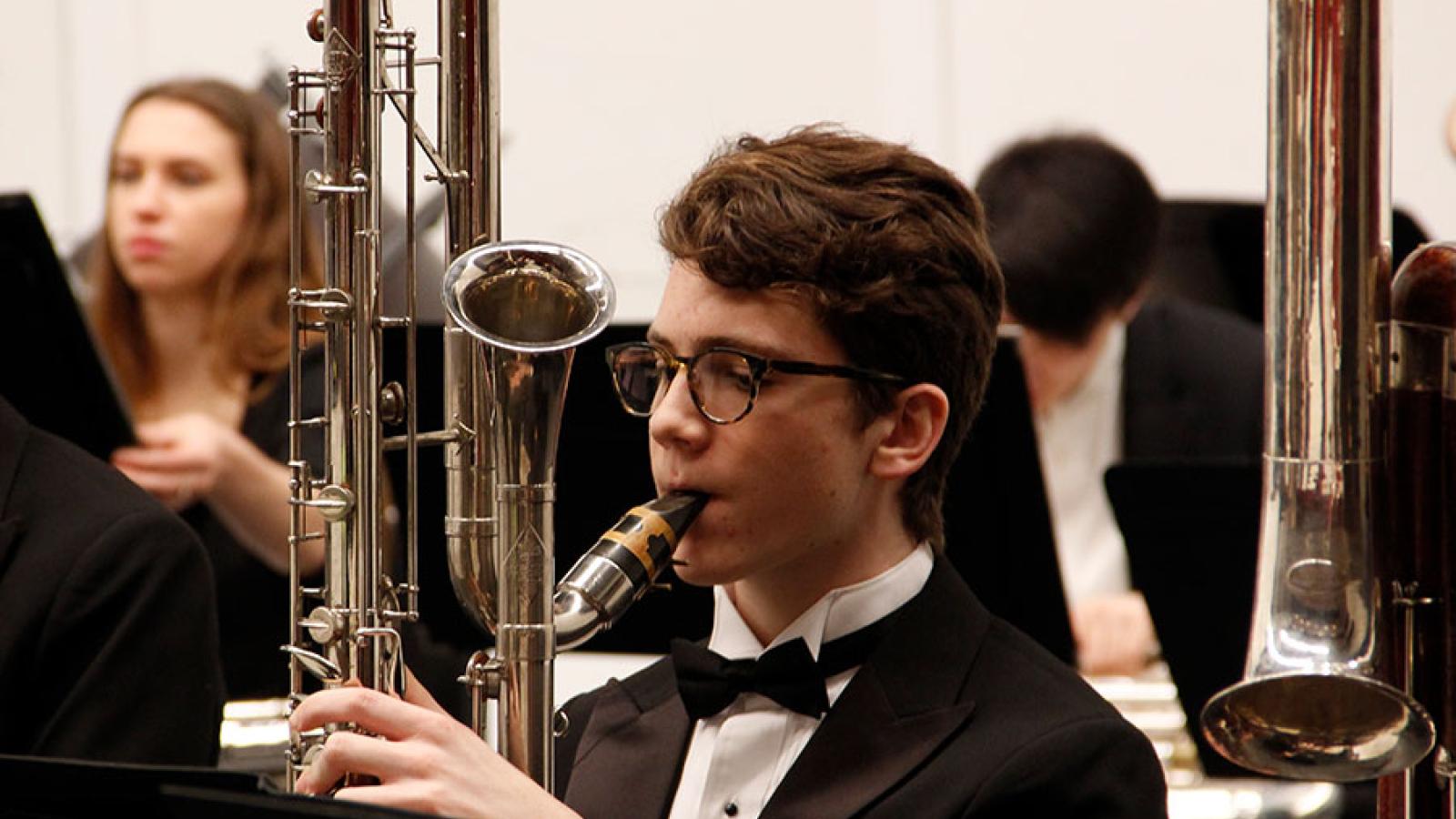 A boy playing contrabass clarinet