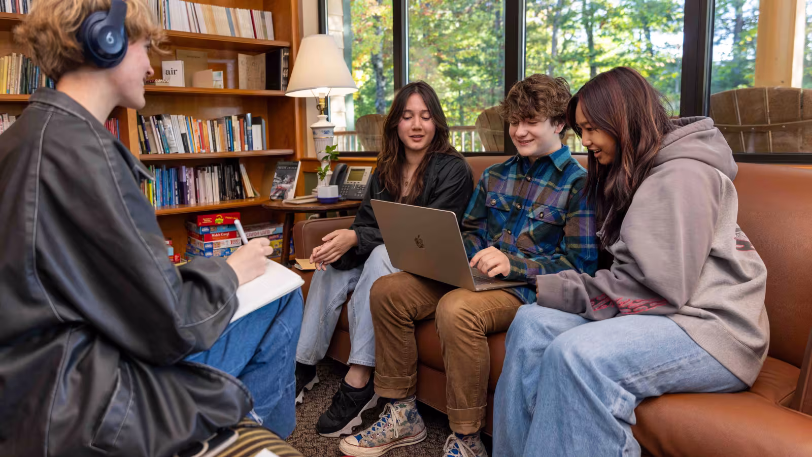 Creative Writing students sit around a computer