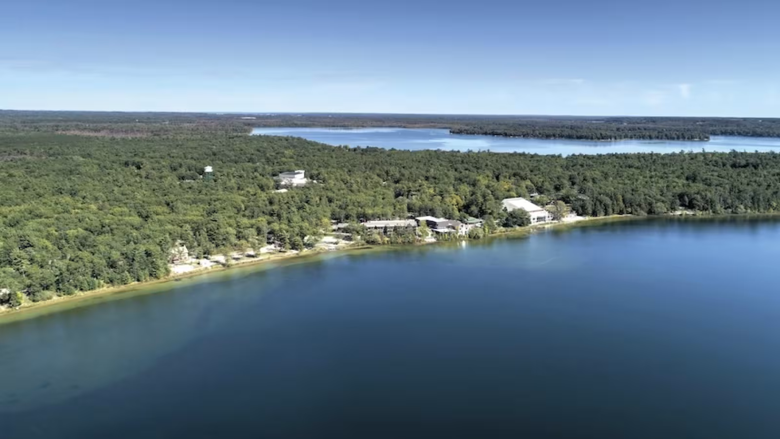 Aerial shot of Interlochen's campus showing the two lakes and pine forests