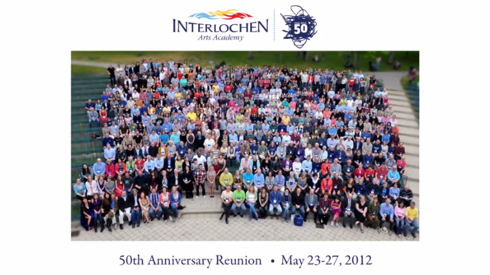 Aerial view of a large group of people seated in an outdoor amphitheater with text indicating a 50th Anniversary Reunion for Interlochen Arts Academy.