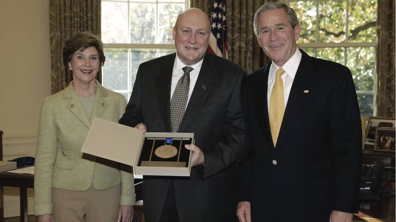 Interlochen President Jeffrey Kimpton accepts the National Medal of Arts from President George W. Bush and the First Lady Laura Bush.