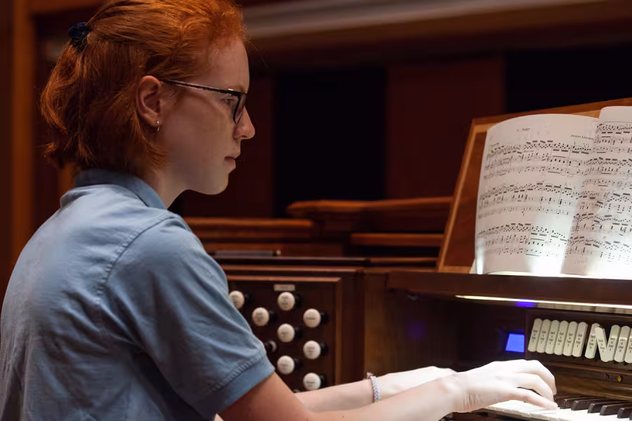 A red-haired girl at an organ