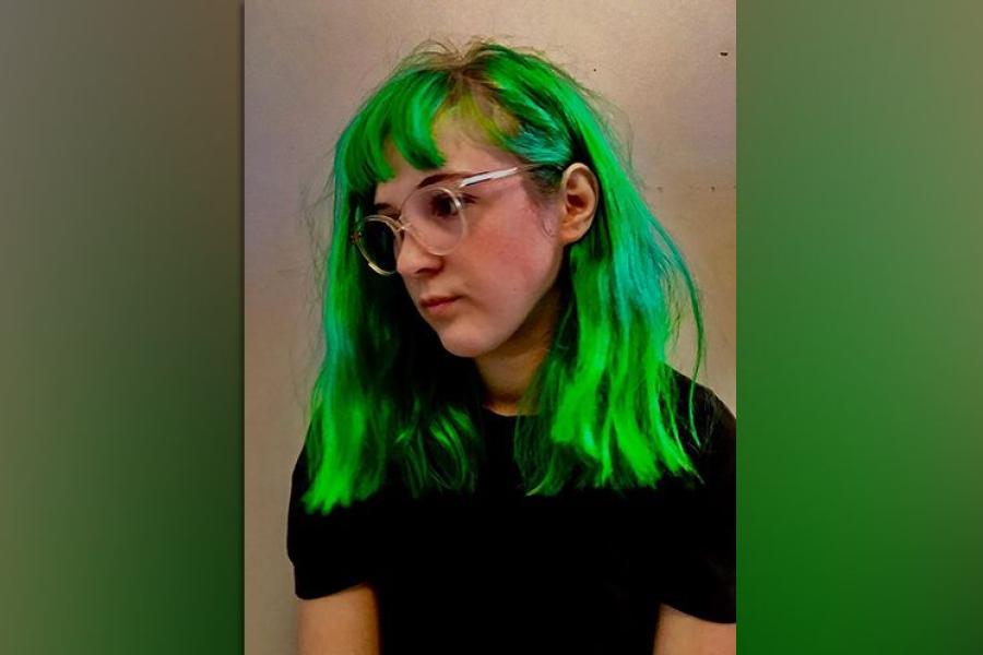 A woman with green hair