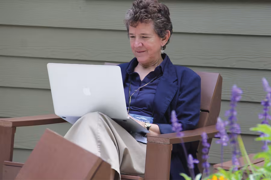 Woman taking creative writing course outdoors with her computer at interlochen college of creative arts