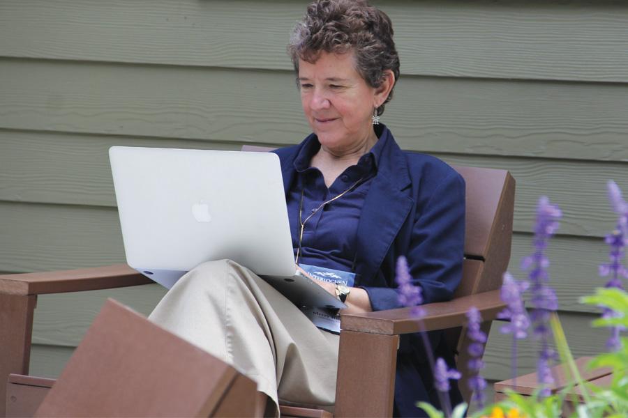 Woman taking creative writing course outdoors with her computer at interlochen college of creative arts