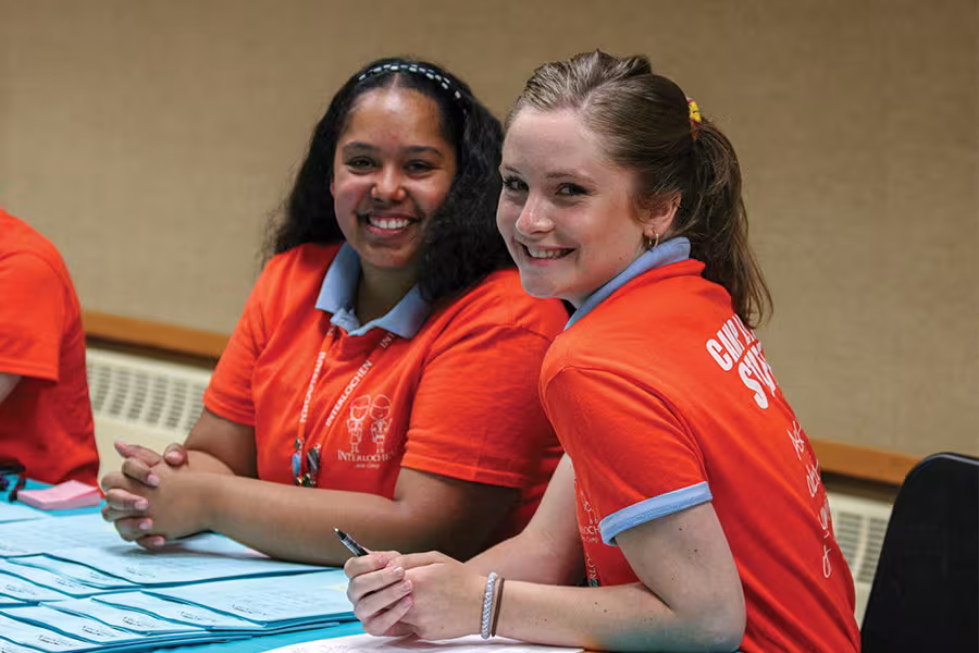 Staff checking in students at the start of camp
