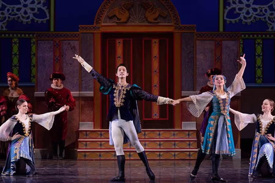 Dancers perform in the ball scene.