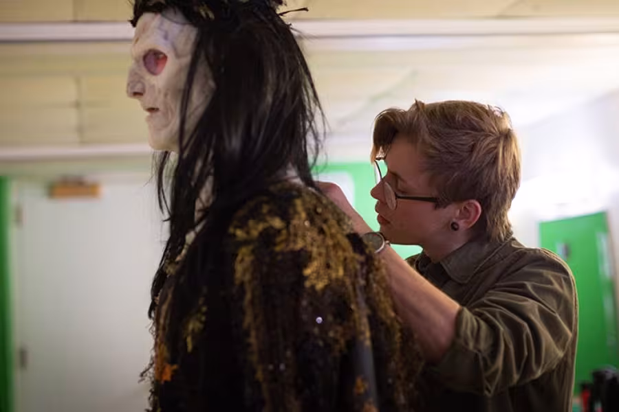 Nick Winstead (right) adjusts Rothbart's mask.