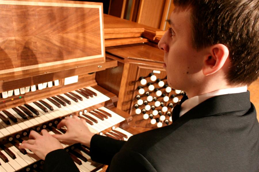 A boy playing the organ