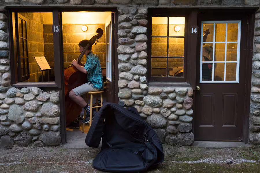 student musicians practice inside huts at interlochen arts camp