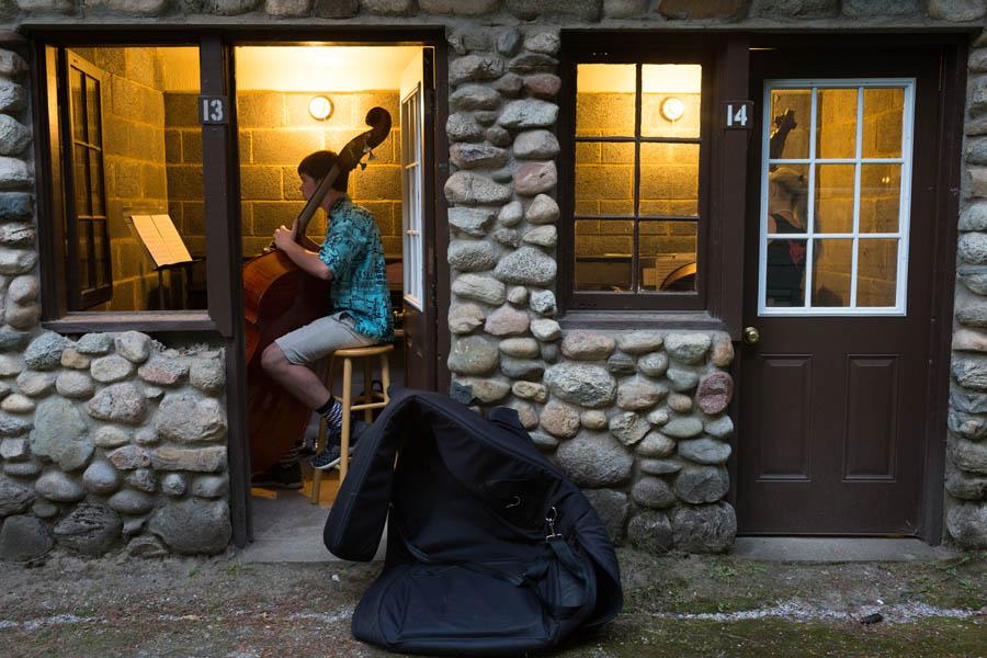 student musicians practice inside huts at interlochen arts camp