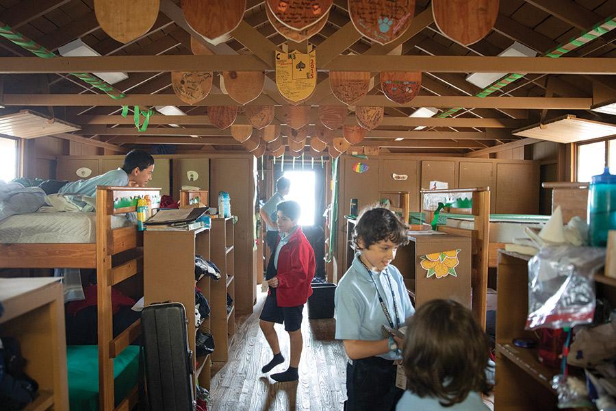 Boys setting up their bunks inside their cabin