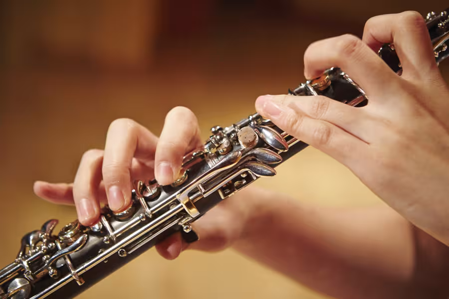 A close up photo of a clarinetist playing their instrument.