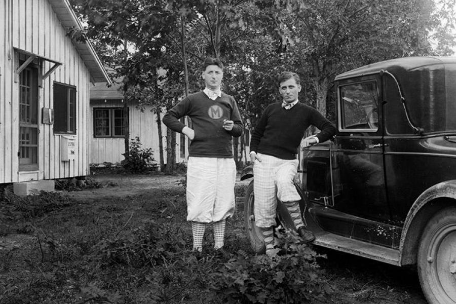 The Falcone brothers standing next to a car