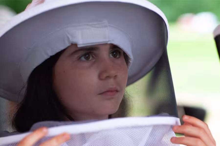 A girl in a beekeeper's veil