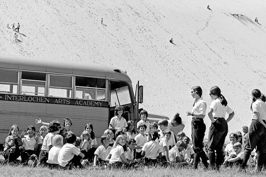 Students get ready to climb a giant sand dune