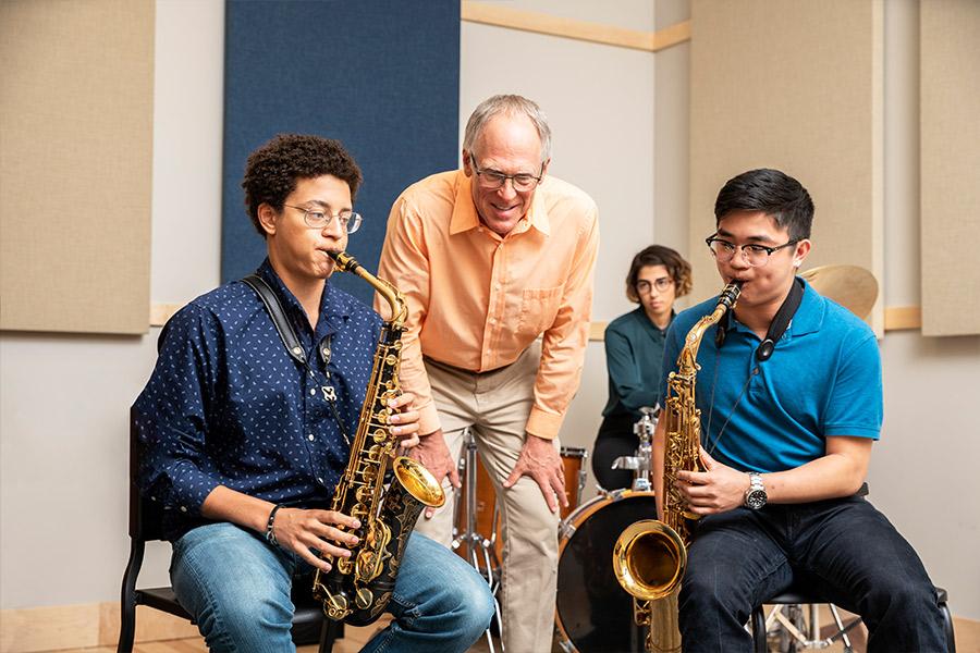 Bill Sears instructs two saxophonists
