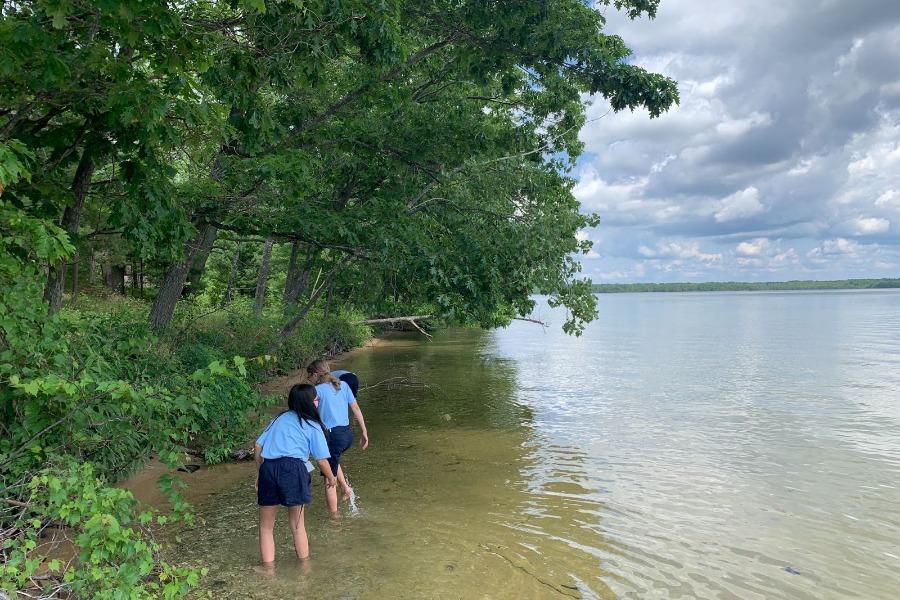 Junior environmental exploration students investigate the aquatic habitat of Green Lake.