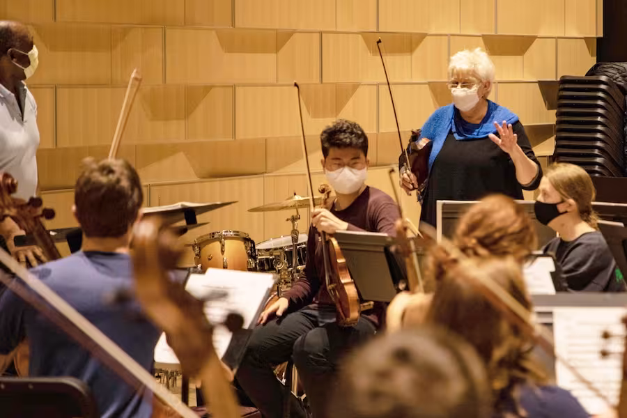 Jorja Fleezanis works with students during and orchestra rehearsal