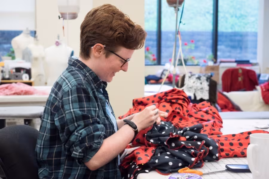 A costume design student in their workspace