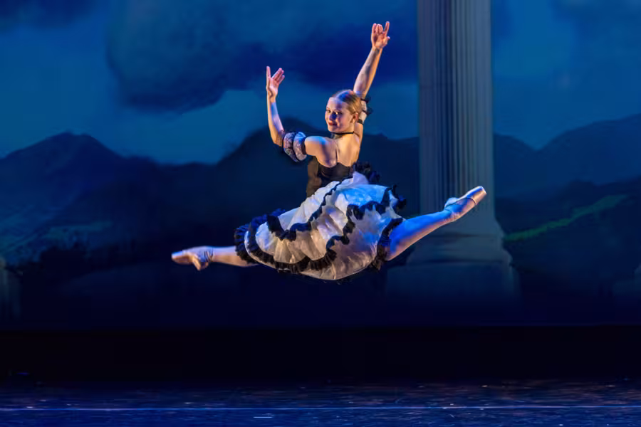A female dance student leaping in the air