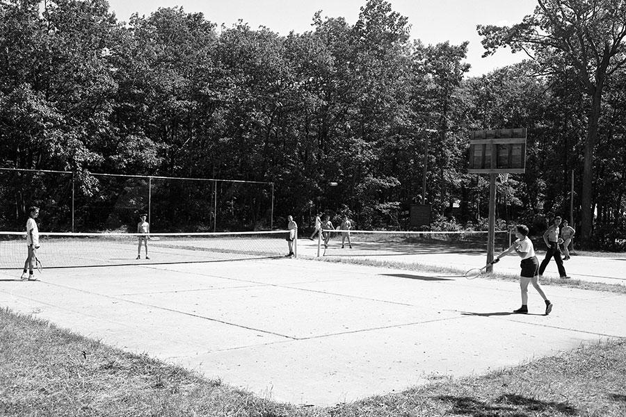 Students play tennis in 1953