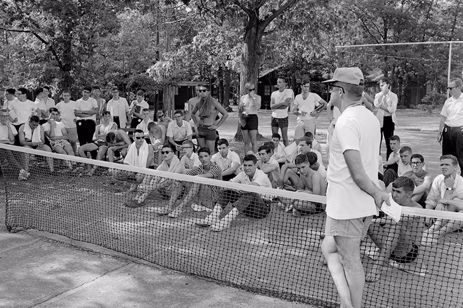 Lee Cabutti leads morning exercises on the High School Boys tennis courts