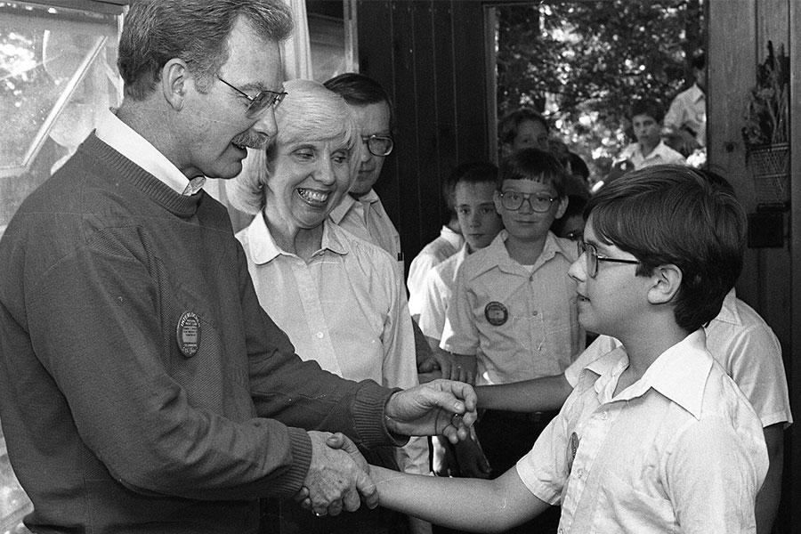 Ed Downing shakes hands with a student during a Camp meet-and-greet.