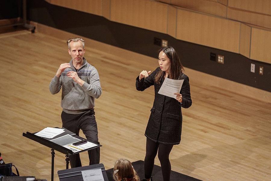 Shuying Li and Matthew Schlomer work with the Arts Academy Wind Symphony