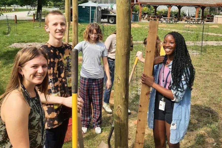 Interlochen Arts Academy students build a fence for a new orchard