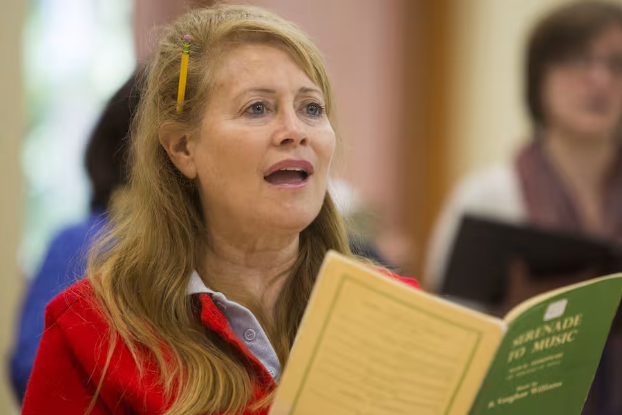 Woman singing in a choir.