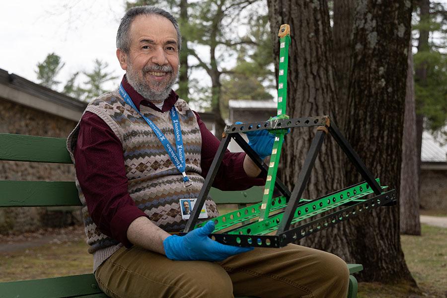 Taoufik Nadji poses with a student's winning catapult.