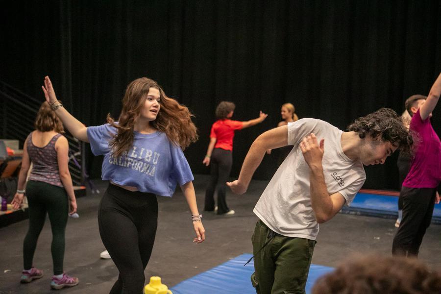 A group of students practice fight choreography.