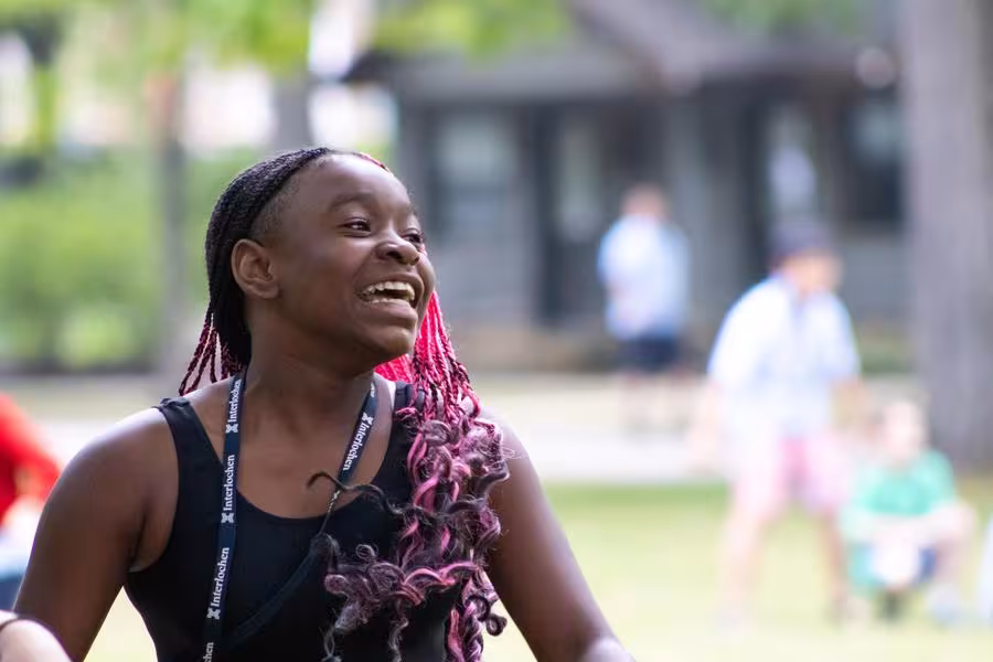 A student laughs during an outdoor game.