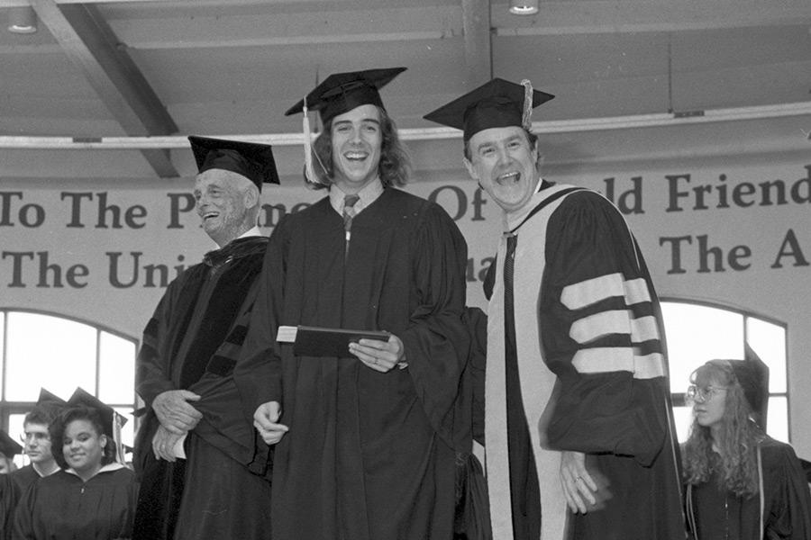 Dean Boal poses with a graduate during the 1990 Interlochen Arts Academy Commencement.