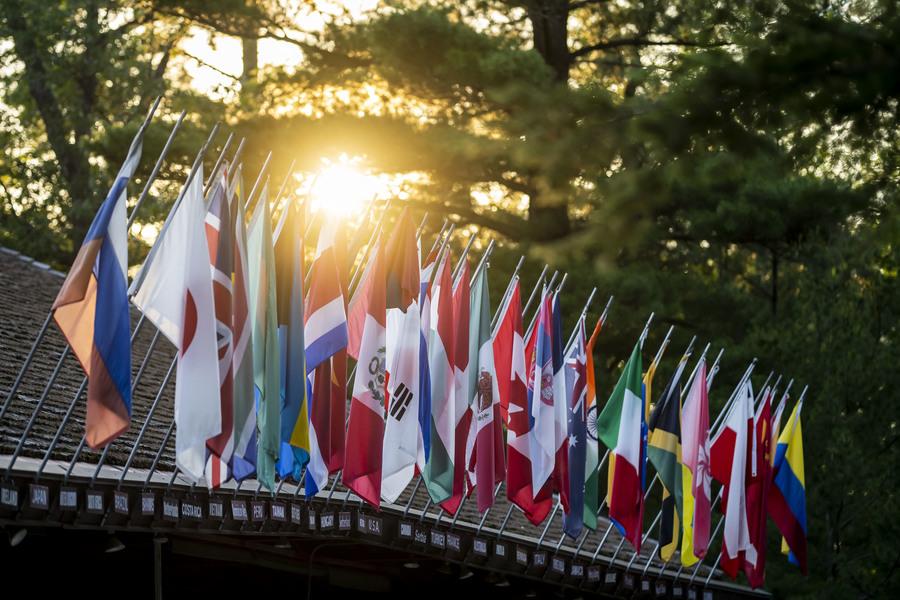 A lineup of international flags adorns the outside of Kresge Auditorium.