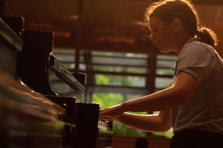 A student playing a piano