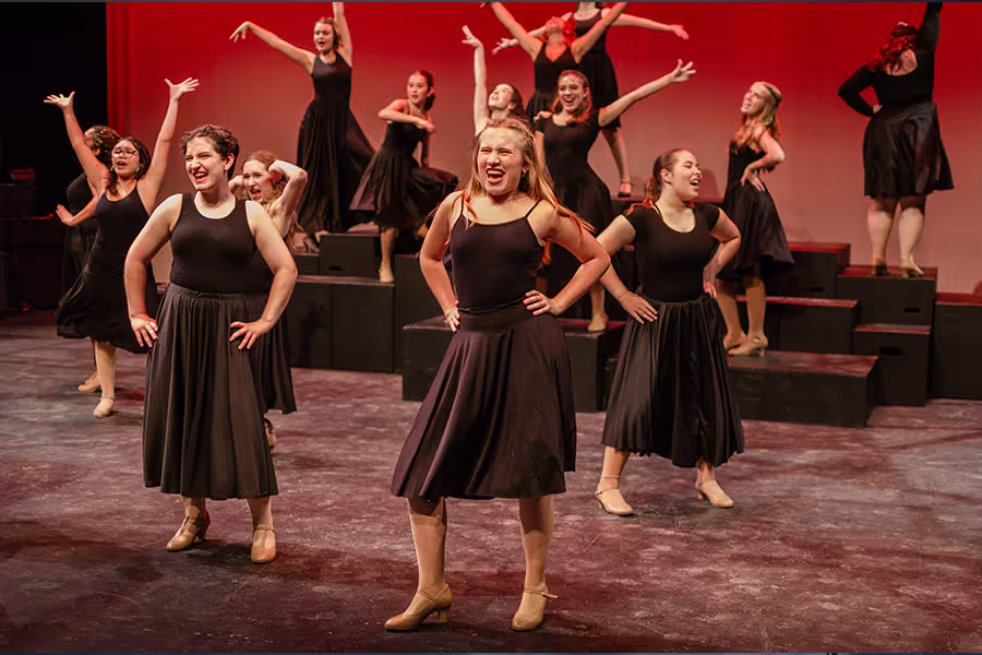 camp students performing dramatically on stage