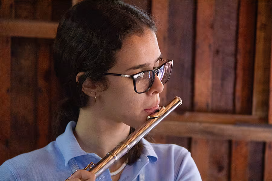 a camp student playing a flute