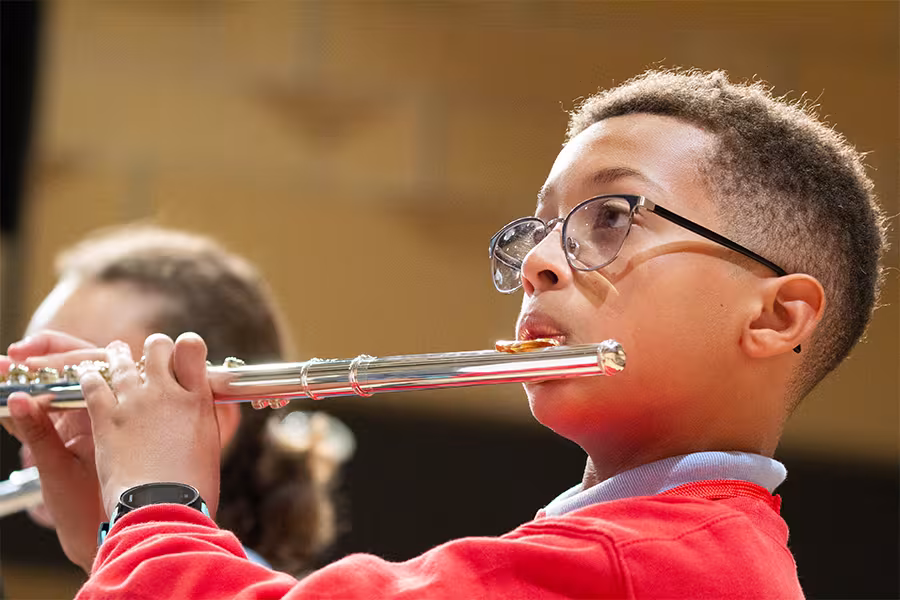 a camp student plays a flute