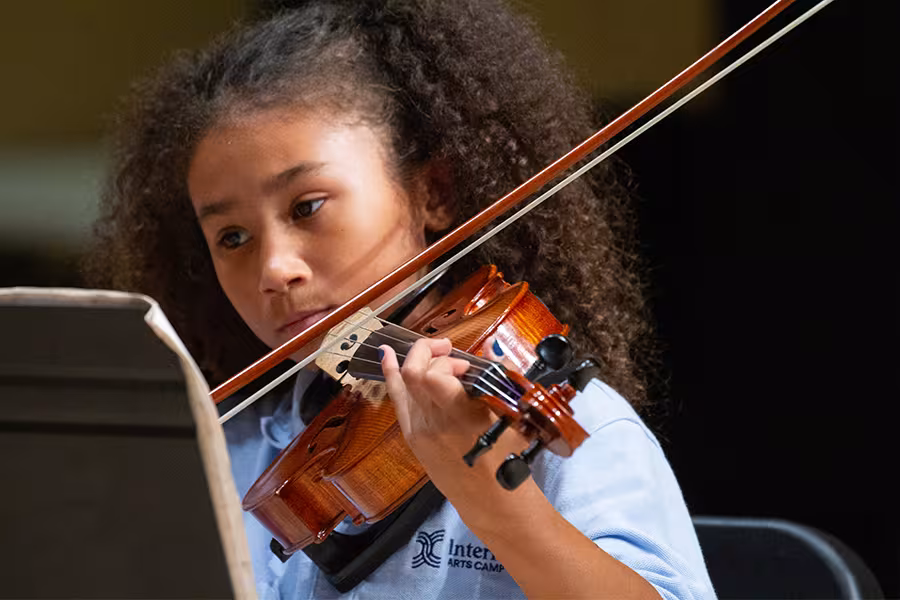 a child plays a violin