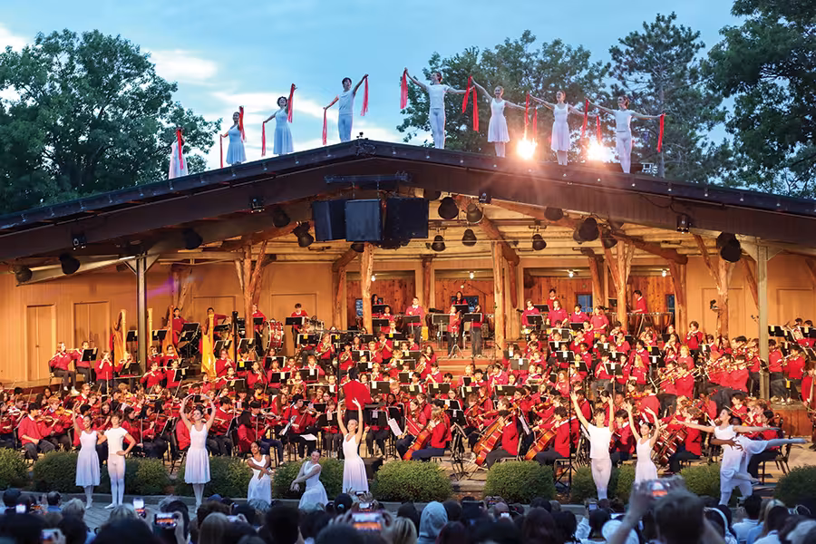 a photo of the summer arts camp's orchestra and dancers performing together