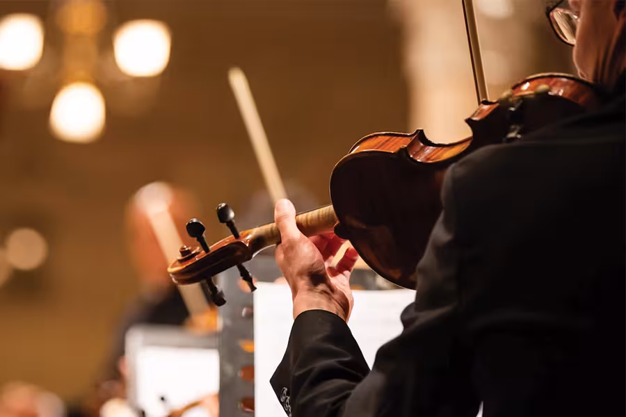 a photo of a person playing a violin